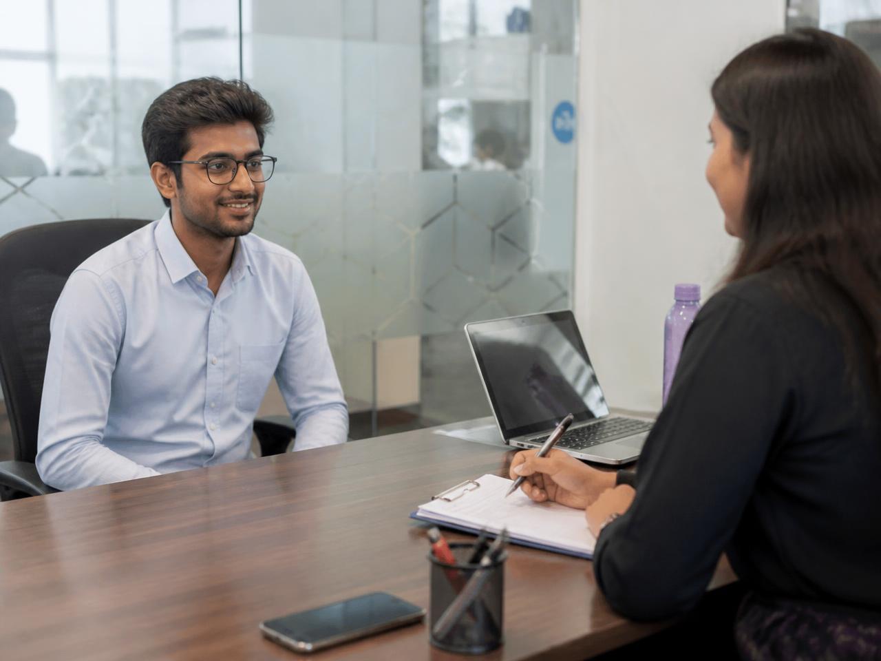 A student answering questions in a mock HR interview with an experienced HR professional